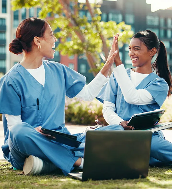 two nurses completing continuing education courses outside